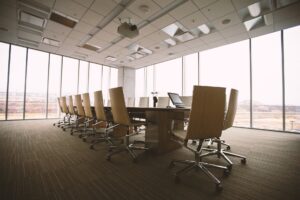 Modern conference room with a long table with a laptop on top of it