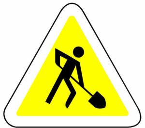 Figure digging representing construction work in progress